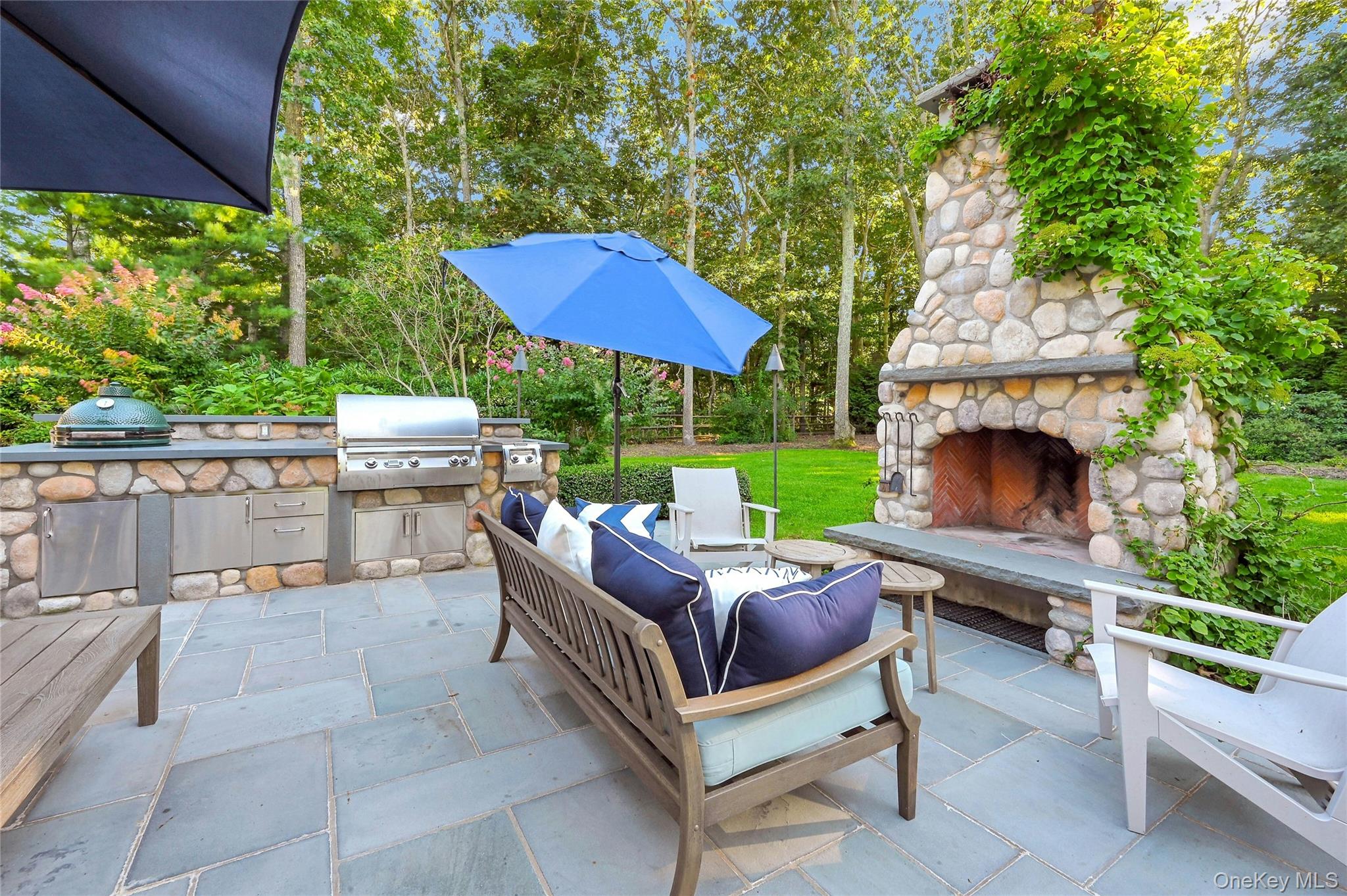 1600 Pine Tree Road Cutchogue, NY 11935 - Photo 24 of 27 a view of a patio with a table chairs and a fire pit