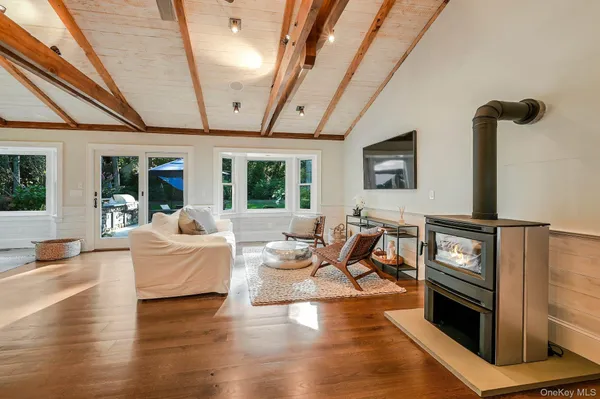 a living room with fireplace furniture and a wooden floor