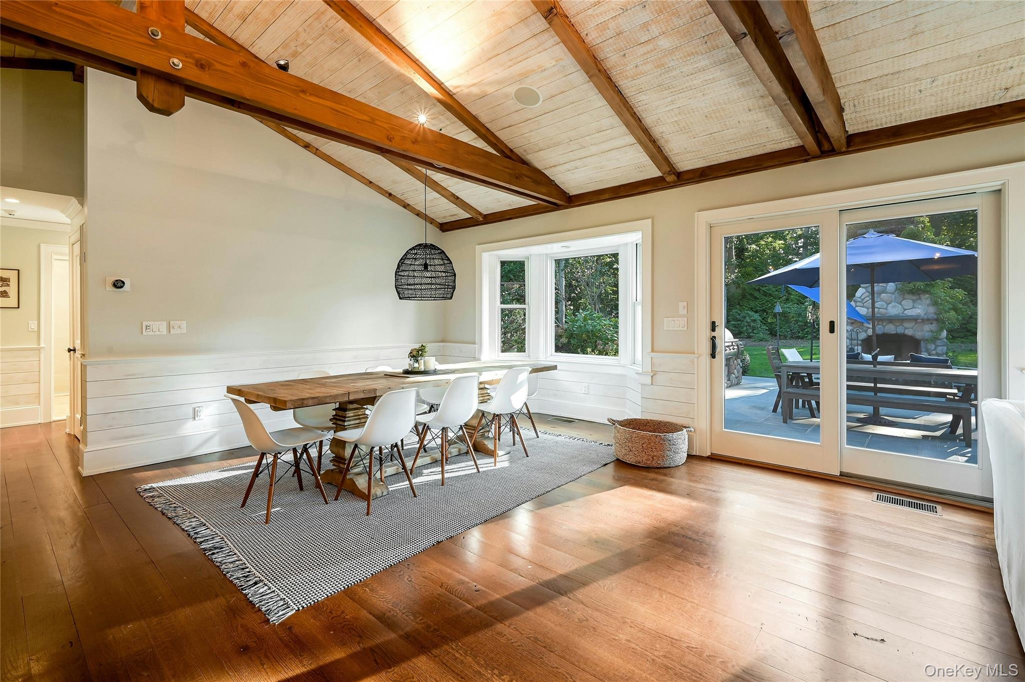 1600 Pine Tree Road Cutchogue, NY 11935 - Photo 6 of 27 a dining room with furniture a chandelier and wooden floor