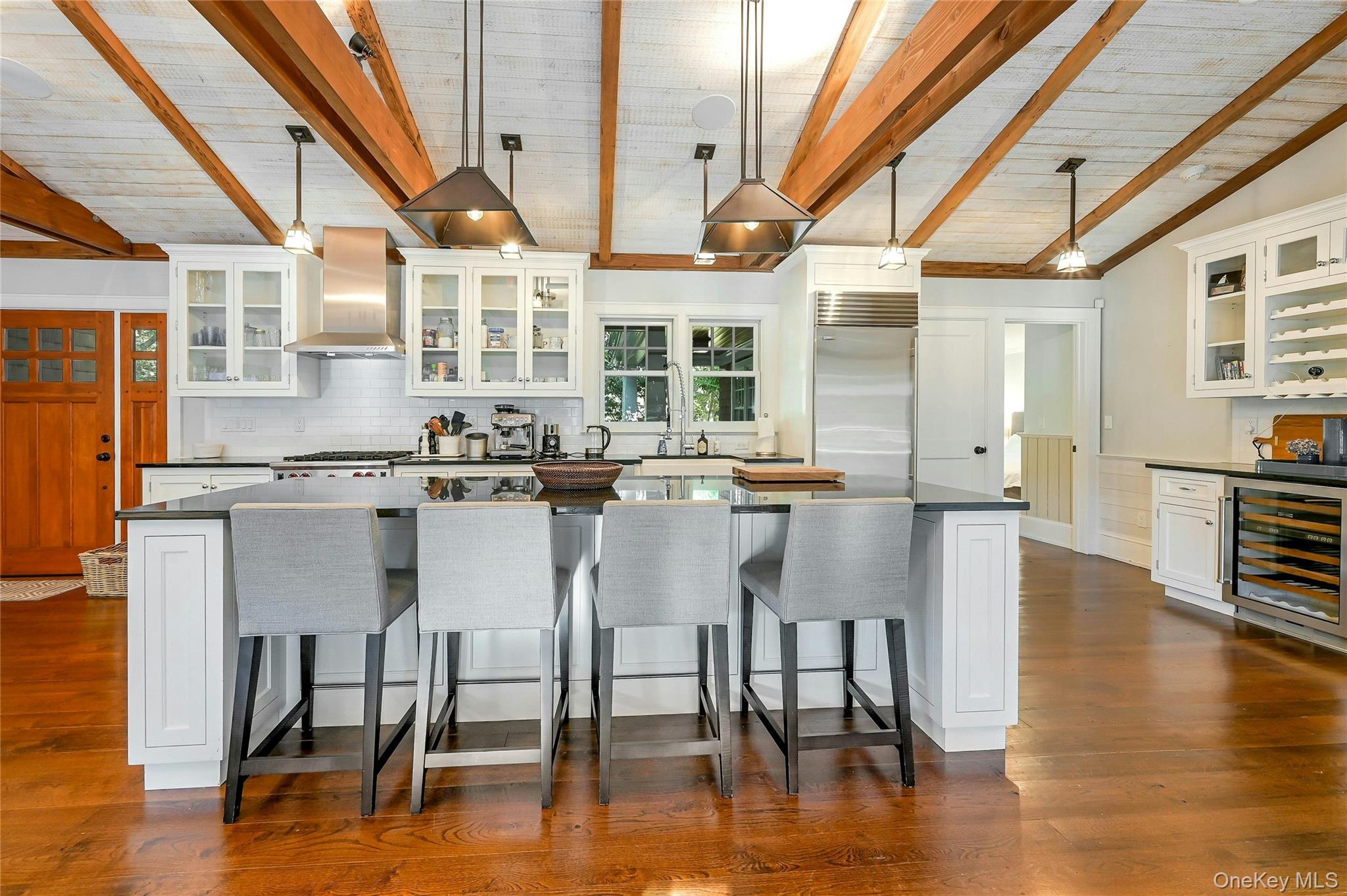 1600 Pine Tree Road Cutchogue, NY 11935 - Photo 7 of 27 a dining table with chairs and wooden floor