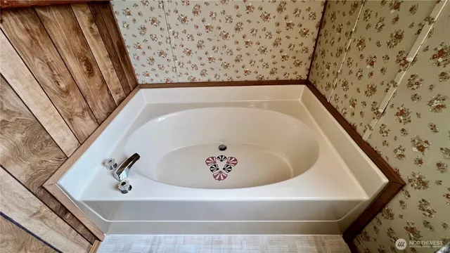 a bathroom with a tub and shower
