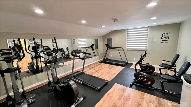 a view of a roof deck with table and chairs a barbeque