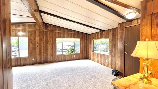 a view of a bedroom with wooden floor and a window
