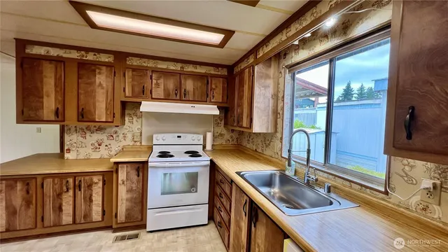a kitchen with a stove and a sink