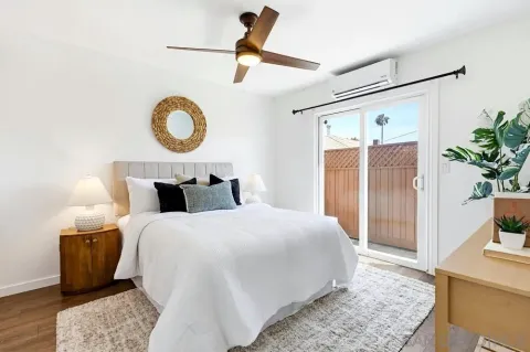 a bedroom with bed and wooden floor