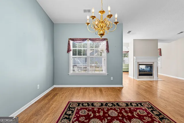 a very nice looking room with wooden floor and a fireplace
