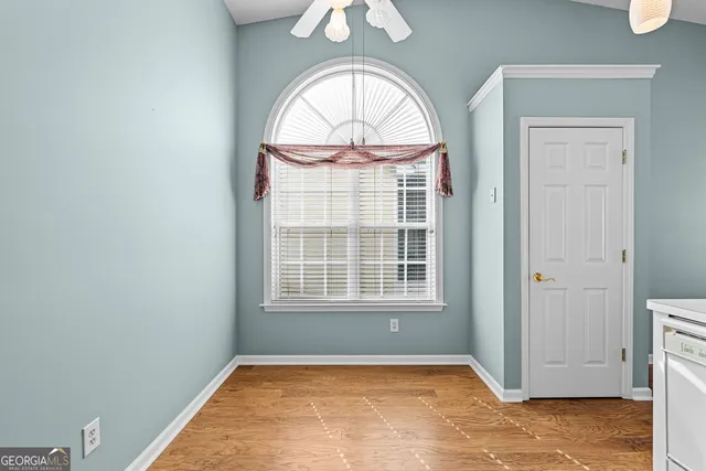 an empty room with windows and entryway