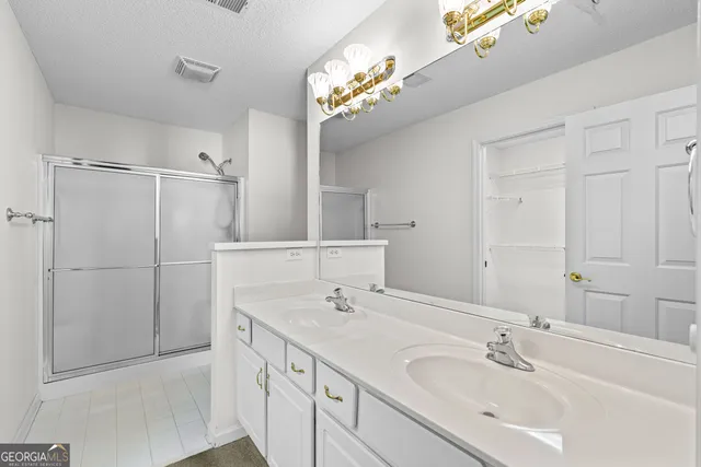 a bathroom with a sink a mirror and a shower