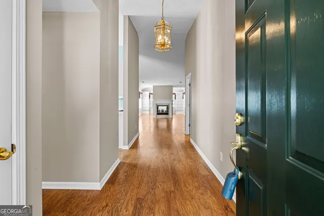 a view of a hallway with wooden floor