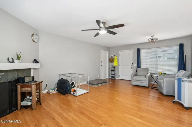 a view of a livingroom with furniture and a ceiling fan