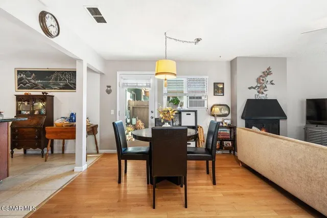 a dining room with furniture a chandelier and wooden floor