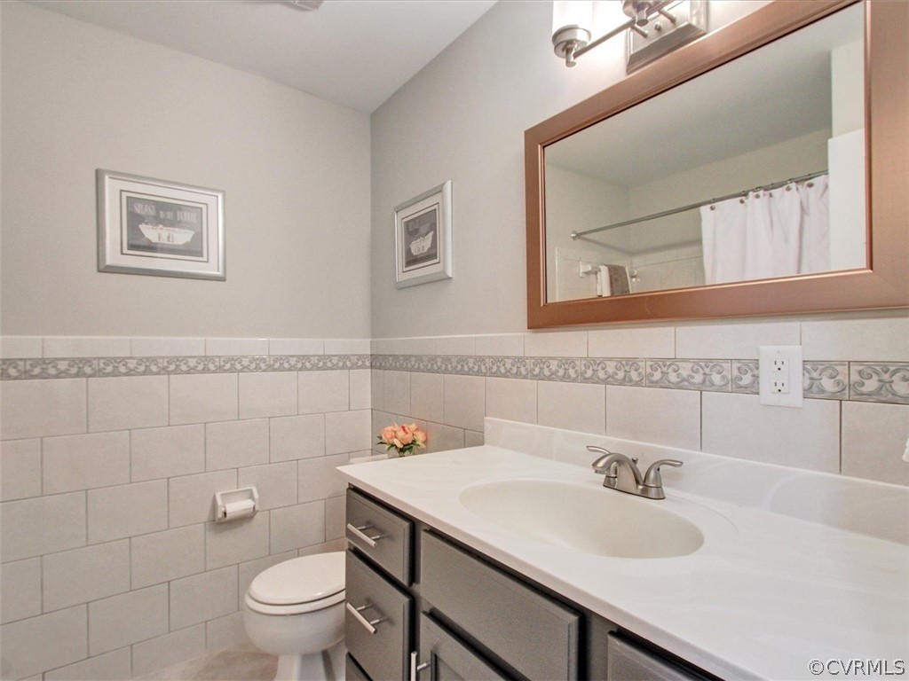 11921 Murray Hill Road Midlothian, VA 23113 - Photo 15 of 34 a bathroom with a granite countertop toilet sink and mirror