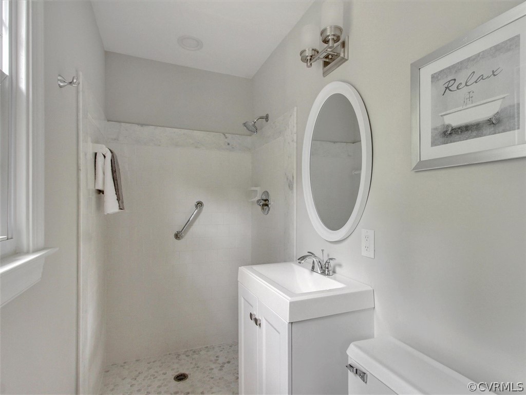 11921 Murray Hill Road Midlothian, VA 23113 - Photo 22 of 34 a bathroom with a sink a mirror and a shower