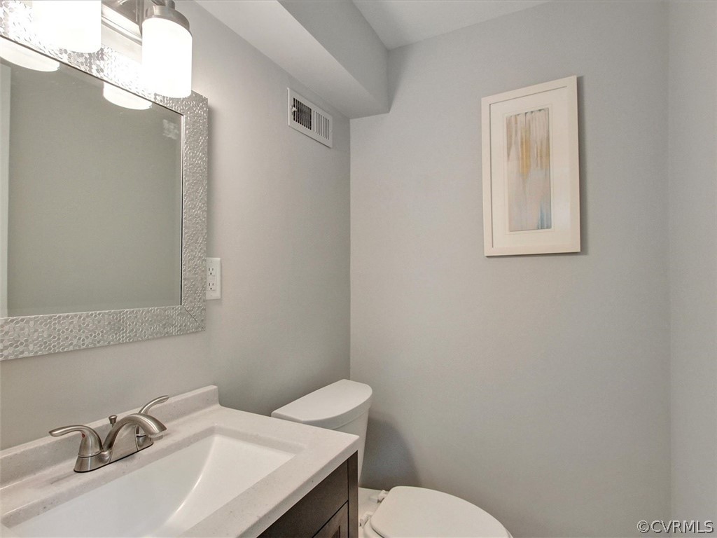 11921 Murray Hill Road Midlothian, VA 23113 - Photo 25 of 34 a bathroom with a sink mirror and toilet