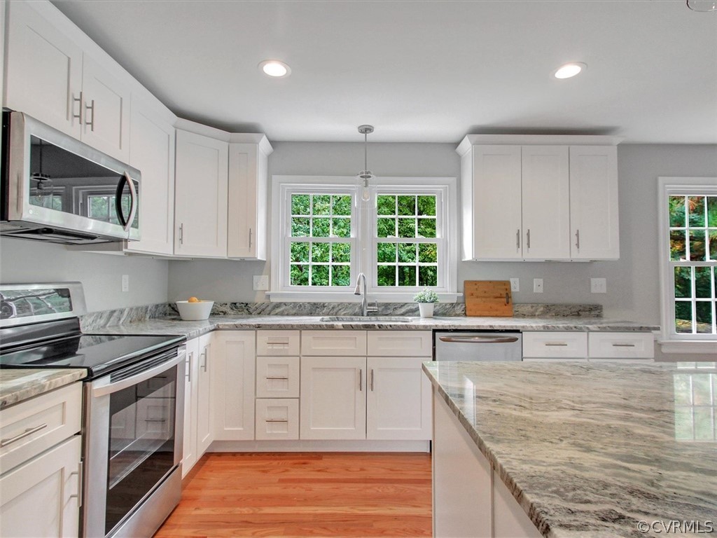 11921 Murray Hill Road Midlothian, VA 23113 - Photo 5 of 34 a kitchen with stainless steel appliances granite countertop a stove a sink and a microwave
