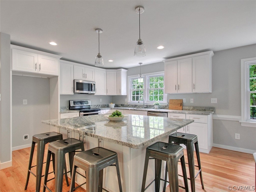 11921 Murray Hill Road Midlothian, VA 23113 - Photo 6 of 34 a kitchen with stainless steel appliances granite countertop a stove top oven a sink refrigerator and cabinets