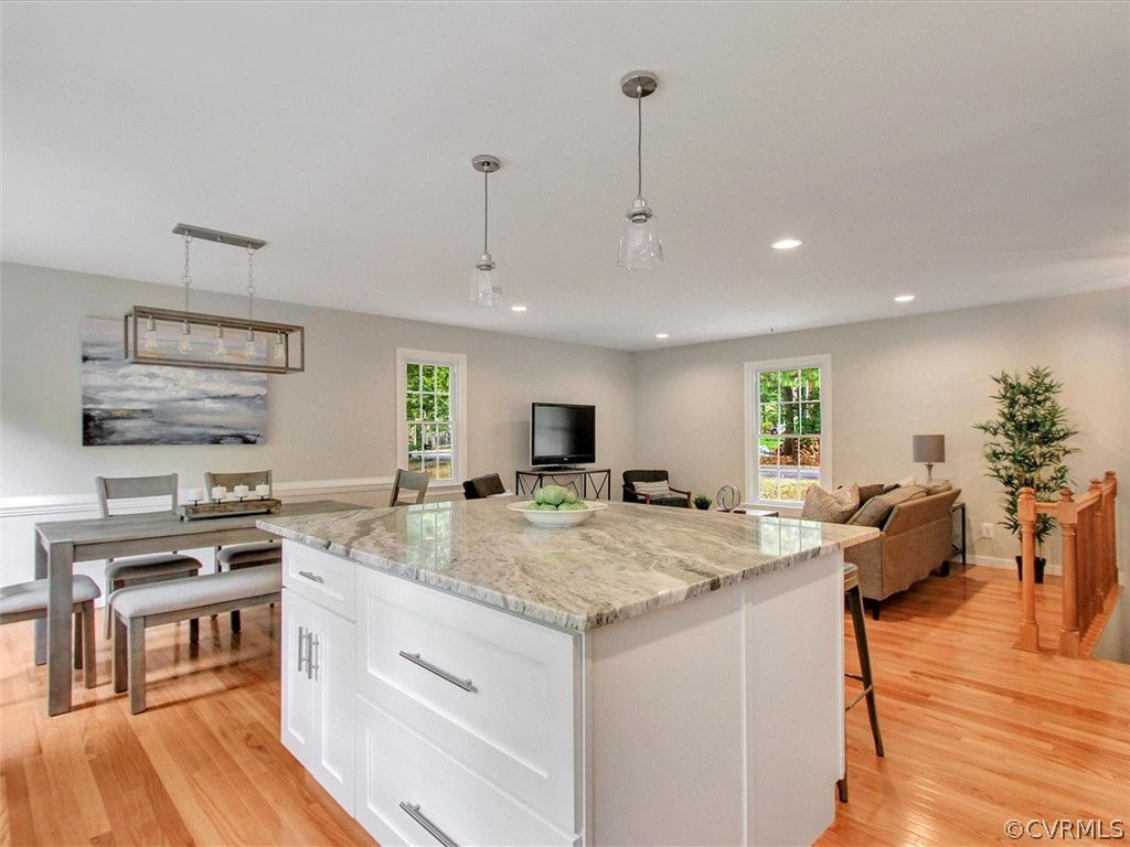 11921 Murray Hill Road Midlothian, VA 23113 - Photo 8 of 34 a kitchen with stainless steel appliances granite countertop a stove oven a dining table and chairs with wooden floor