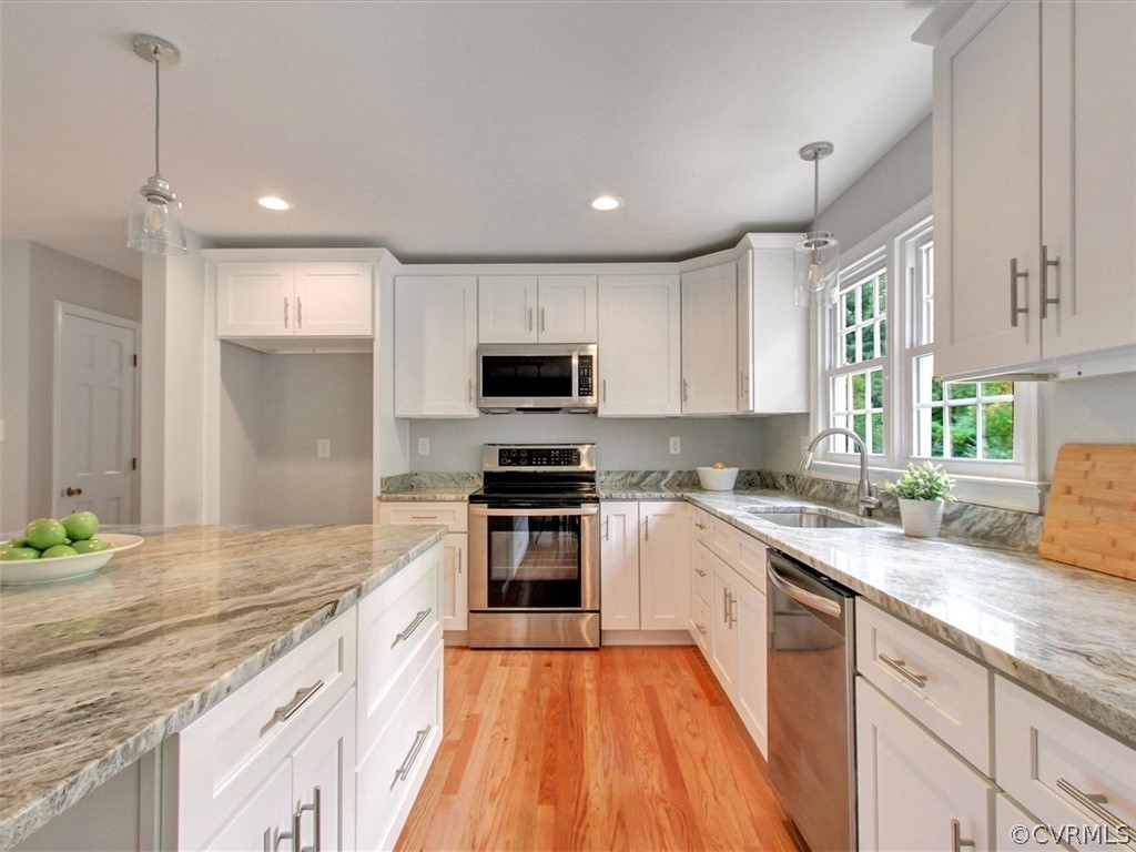 11921 Murray Hill Road Midlothian, VA 23113 - Photo 10 of 34 a large kitchen with granite countertop a sink and dishwasher a stove top oven with wooden floor
