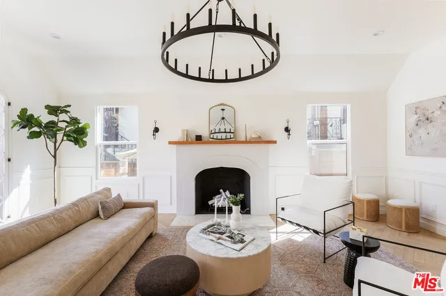 a living room with furniture a window and a fireplace