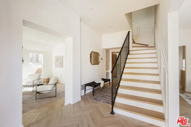a livingroom with furniture and stairs