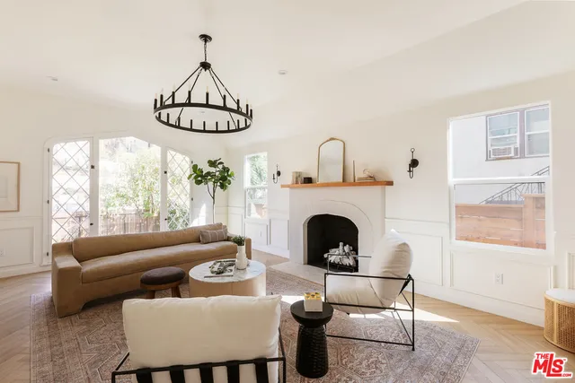 a living room with furniture a fireplace and window
