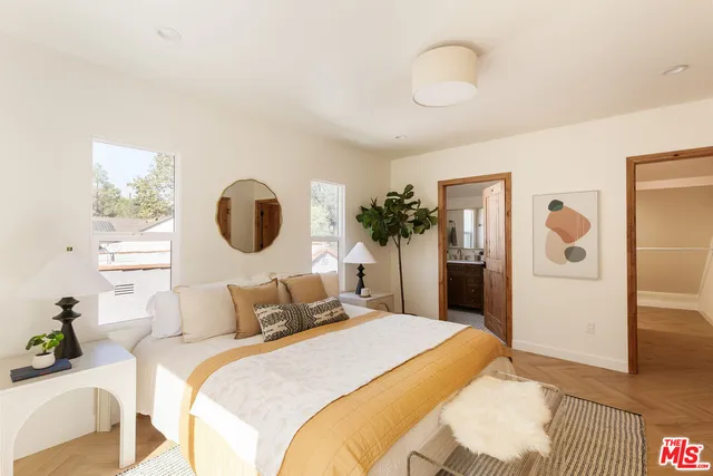 a bedroom with a bed and a painting on the wall