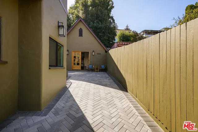 a view of a house with a wooden fence