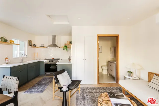 a kitchen with a sink and a stove top oven