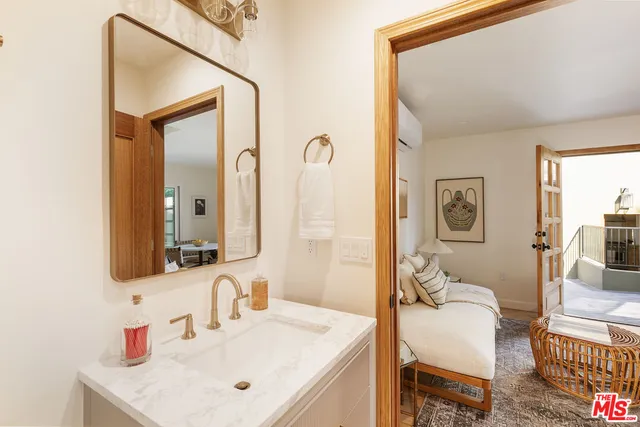 a bathroom with a sink vanity granite and a mirror