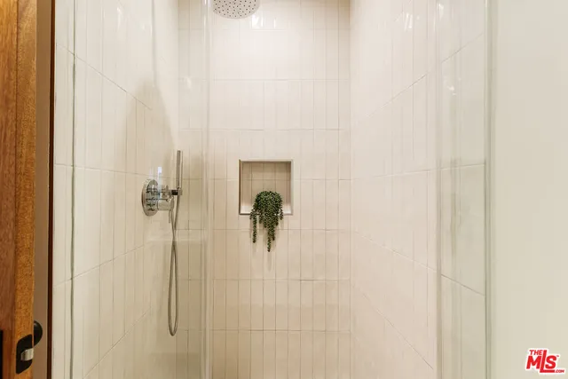a front view of a house with a yard and potted plants