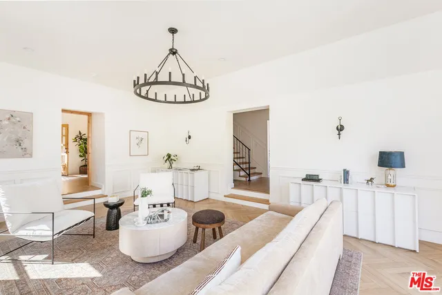 a living room with furniture a window and a table