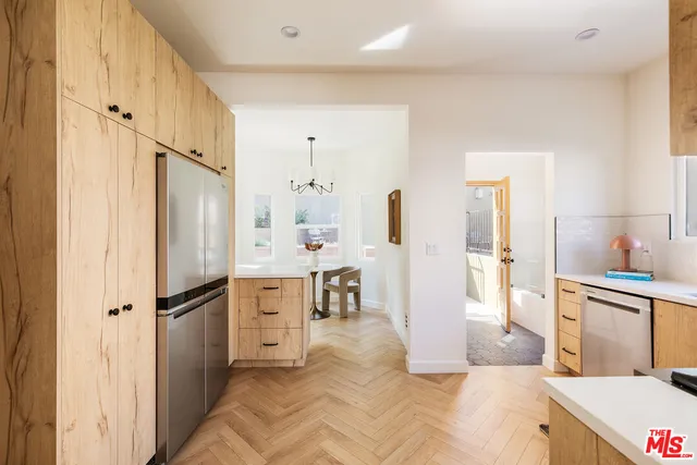 a large white kitchen with cabinets