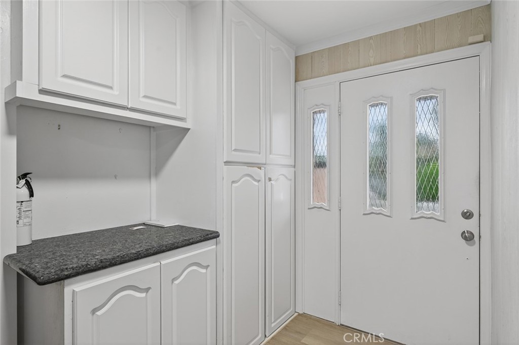 4060 Alto Street Oceanside, CA 92056 - Photo 12 of 56 a kitchen with white cabinets and a sink