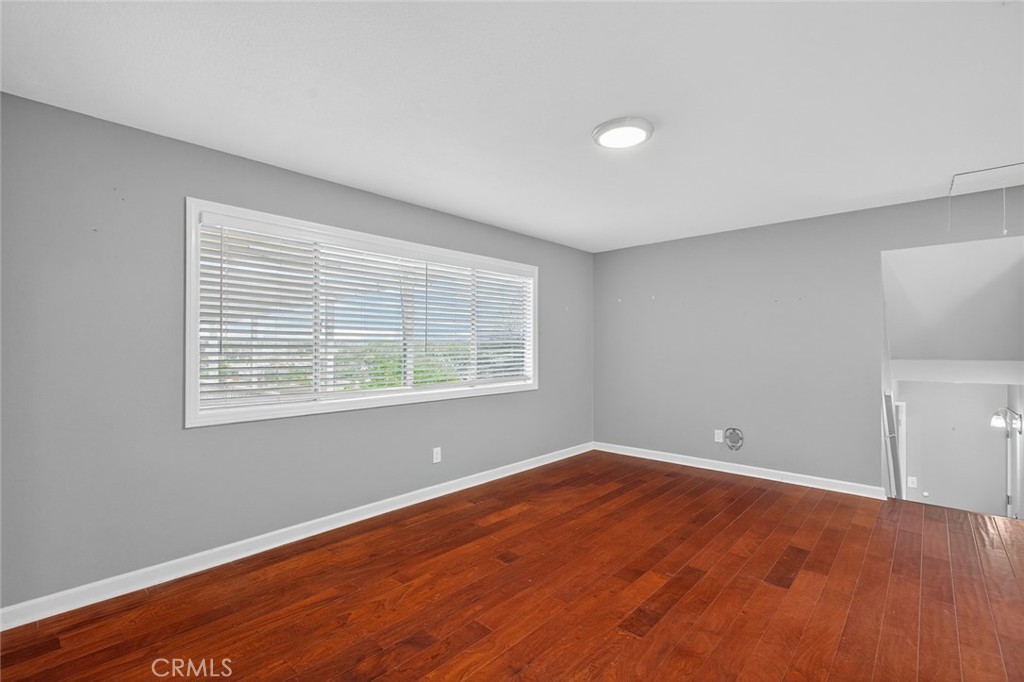 4060 Alto Street Oceanside, CA 92056 - Photo 16 of 56 an empty room with wooden floor and windows
