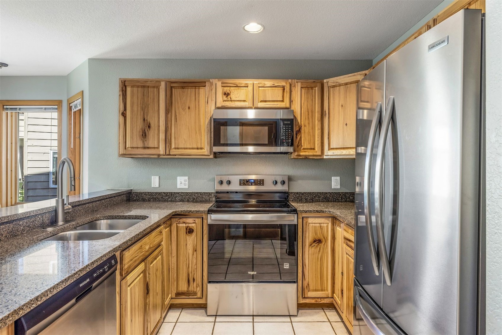 60 Oro Grande Road, Unit 204 Keystone, CO 80435 - Photo 8 of 50 a kitchen with stainless steel appliances granite countertop a stove a sink and a microwave