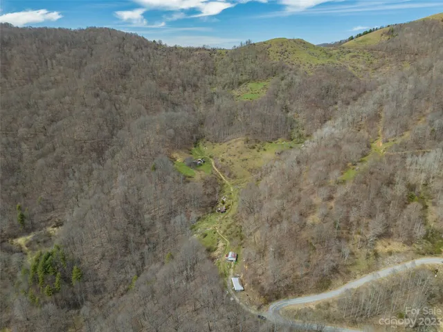 a view of a dry yard with mountains in the background