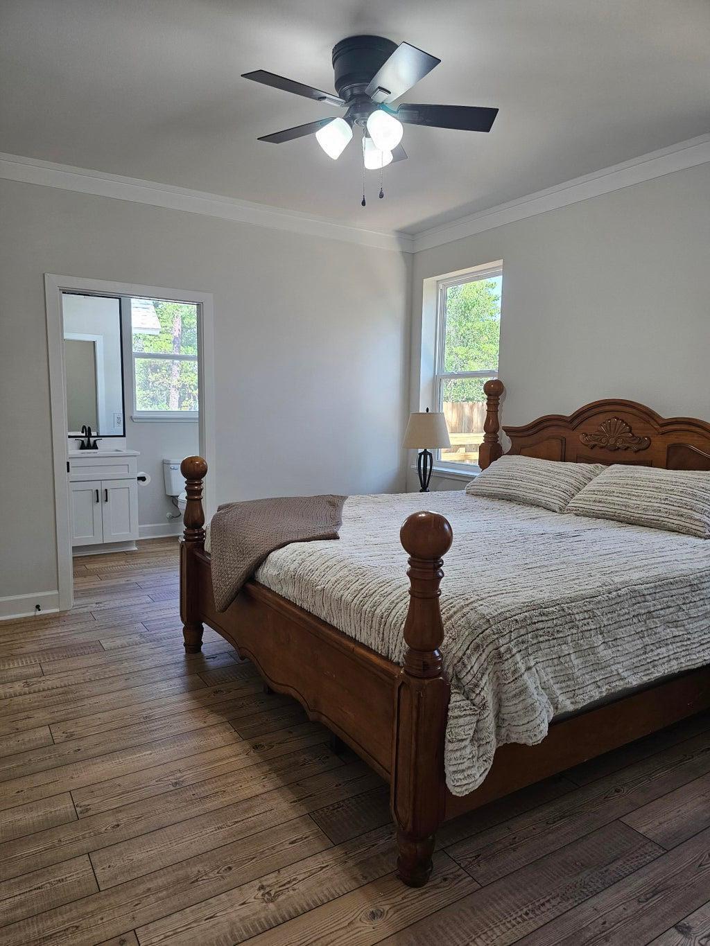 45 Laurel Oak Lane Santa Rosa Beach, FL 32459 - Photo 12 of 30 a bedroom with a bed and wooden floor