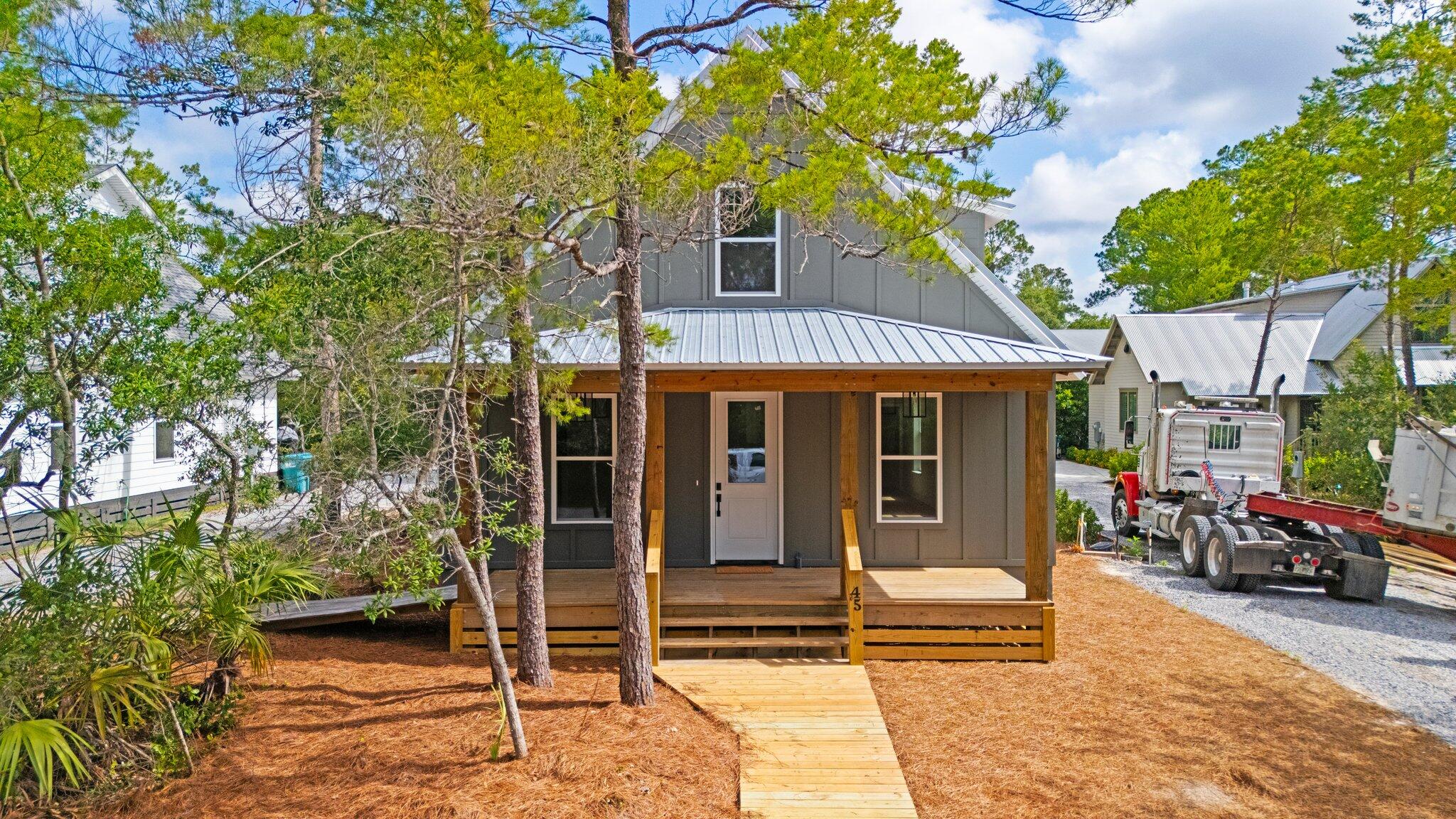 45 Laurel Oak Lane Santa Rosa Beach, FL 32459 - Photo 16 of 30 a front view of a house with a garden