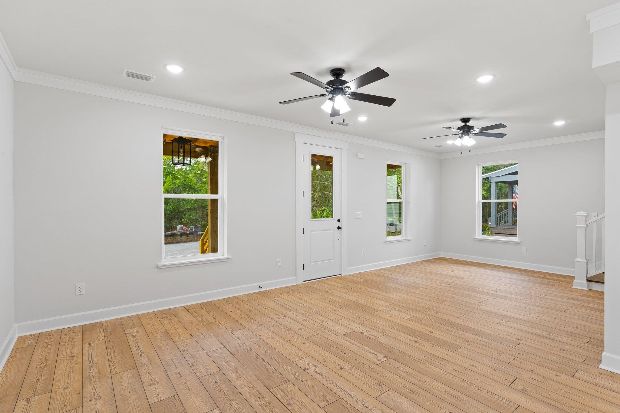45 Laurel Oak Lane Santa Rosa Beach, FL 32459 - Photo 21 of 30 a view of an empty room with a window and wooden floor