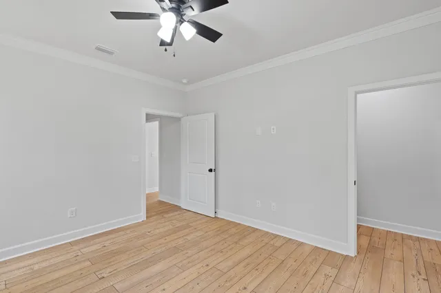 a view of empty room with wooden floor