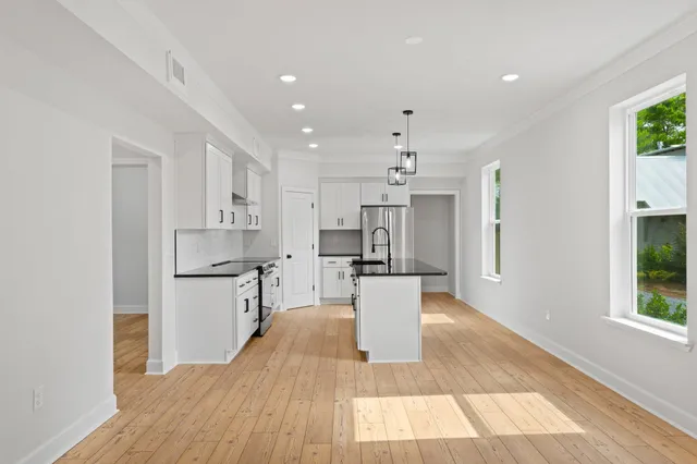 a kitchen with stainless steel appliances a refrigerator sink and stove