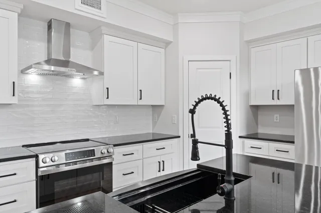 a kitchen with stainless steel appliances a stove and a refrigerator