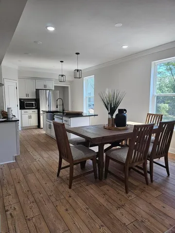 a view of a dining room with furniture and wooden floor