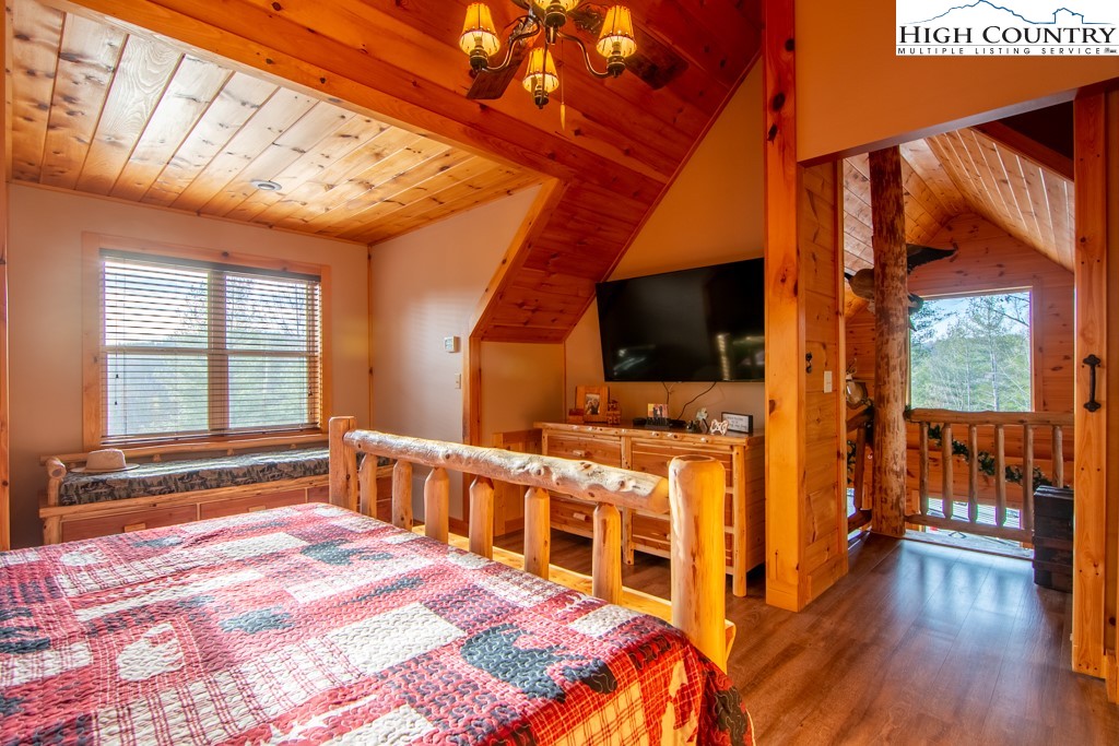 232 Bertie Circle Piney Creek, NC 28663 - Photo 18 of 50 a bedroom with furniture window and flat screen tv