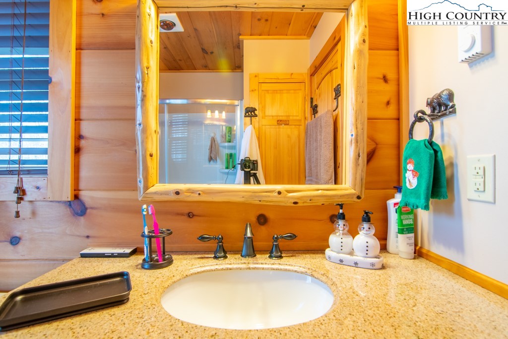 232 Bertie Circle Piney Creek, NC 28663 - Photo 20 of 50 a bathroom with a sink and a mirror
