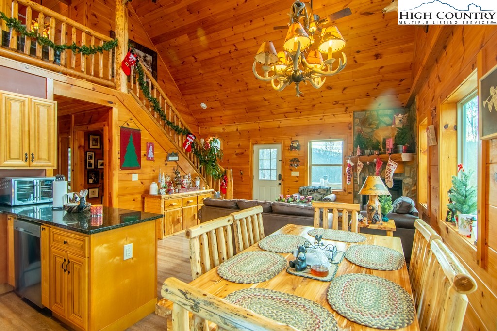 232 Bertie Circle Piney Creek, NC 28663 - Photo 28 of 50 a dining room filled with lots of furniture and a chandelier
