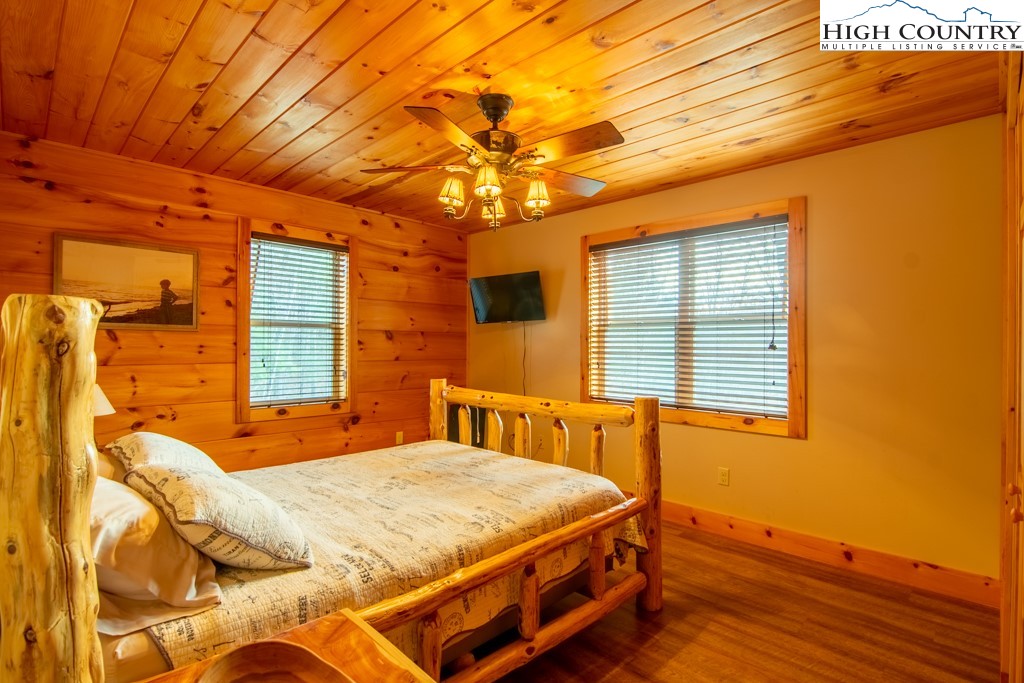 232 Bertie Circle Piney Creek, NC 28663 - Photo 33 of 50 a bedroom with a bed and wooden floor