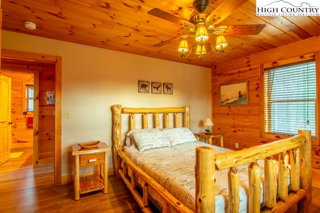 232 Bertie Circle Piney Creek, NC 28663 - Photo 34 of 50 a bed sitting in a bedroom next to a window