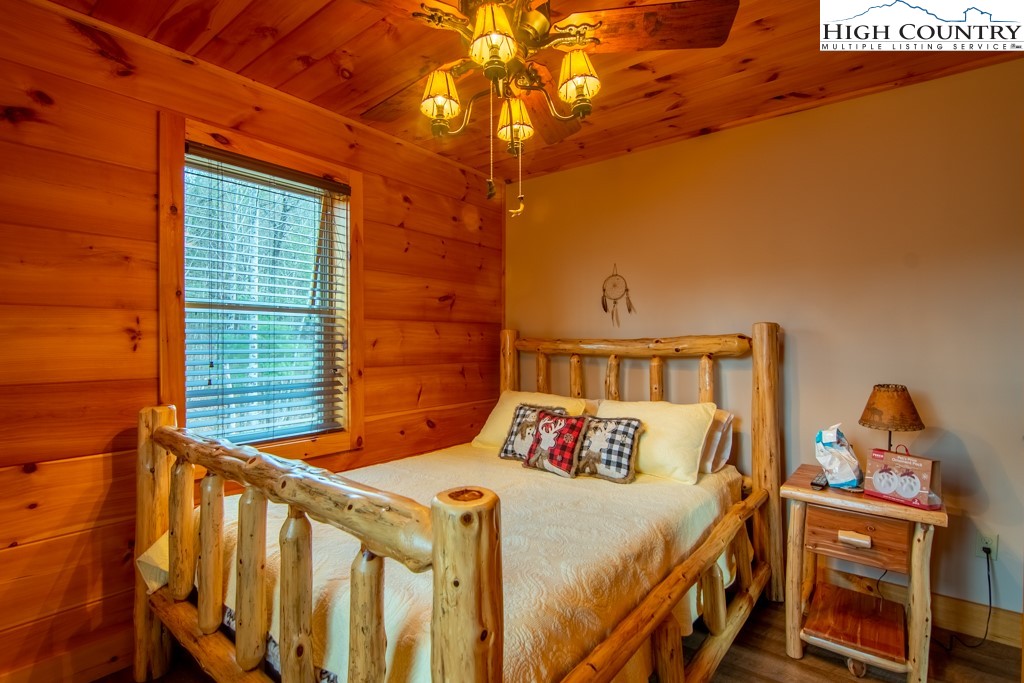 232 Bertie Circle Piney Creek, NC 28663 - Photo 35 of 50 a bed sitting in a bedroom next to a window