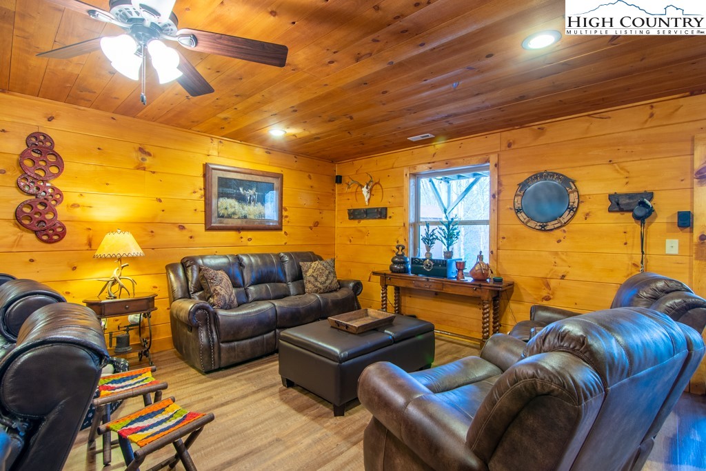 232 Bertie Circle Piney Creek, NC 28663 - Photo 40 of 50 a living room with furniture and a flat screen tv